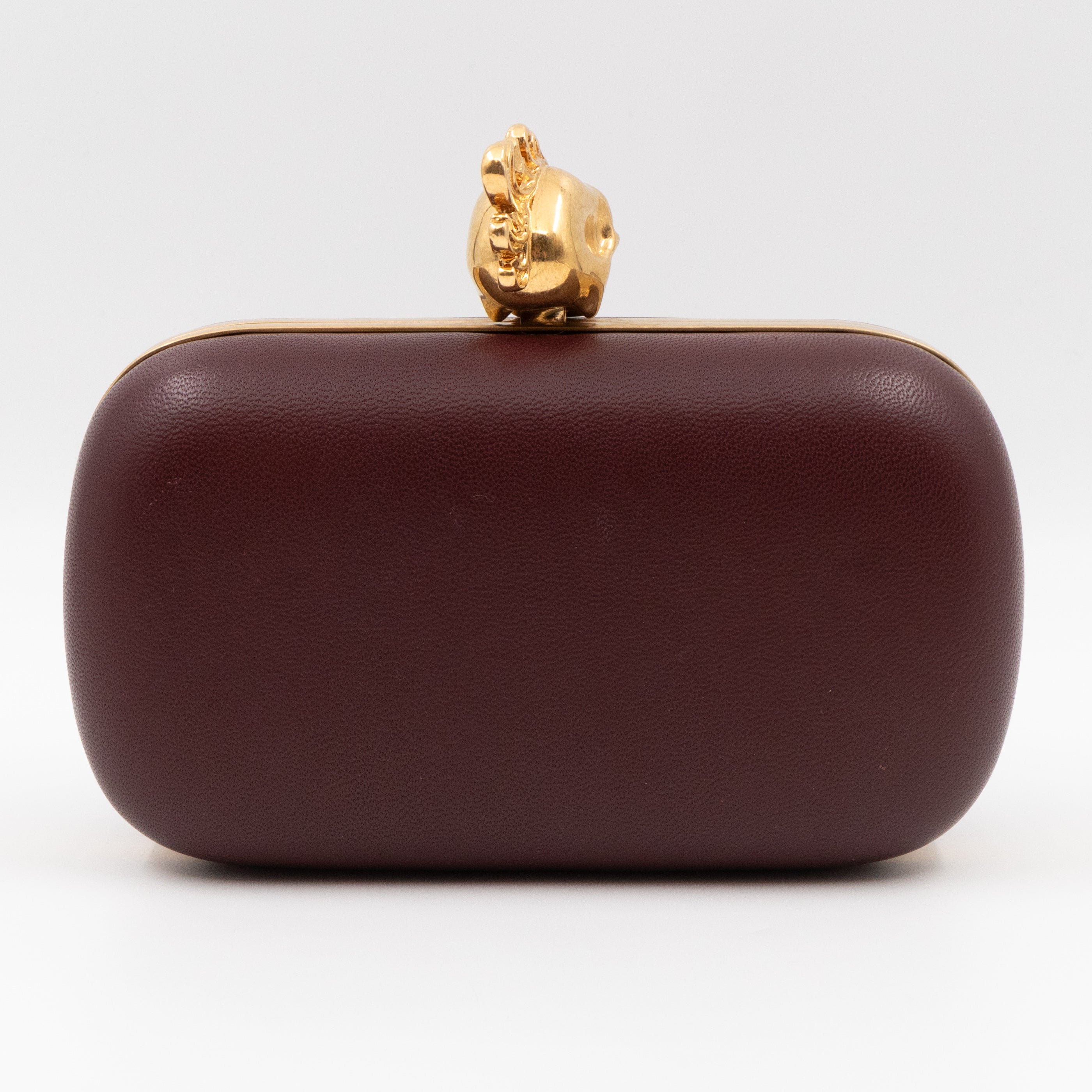 Burgundy and outlet gold clutch bag